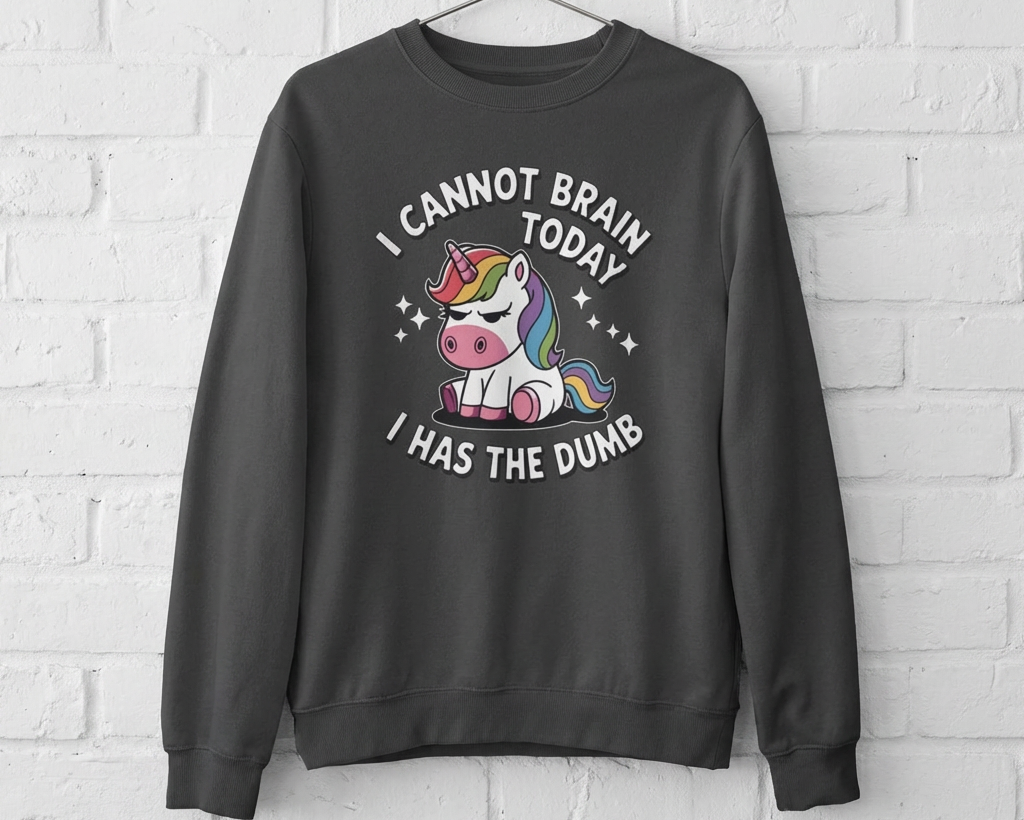 Gray sweatshirt with a unicorn graphic and text on a white brick wall background