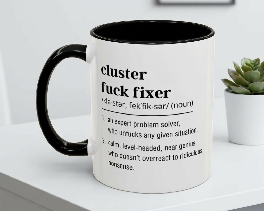 Mug with definition text on a white surface with a plant in the background