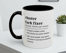 Mug with definition text on a white surface with a plant in the background