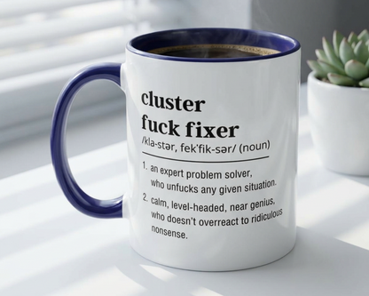 Mug with text definition on a white surface with a plant in the background