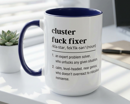 Mug with text definition on a desk with a plant and phone in the background