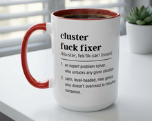 Mug with text definition on a desk with a plant in the background