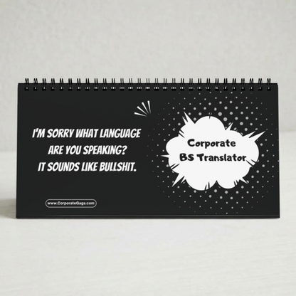 A black spiral-bound desk calendar or sign with white text that reads, 'I'M Sorry WHAT LANGUAGE ARE YOU SPEAKING? IT SOUNDS LIKE Bullshit.' and a speech-bubble graphic reading 'Corporate BS Translator.