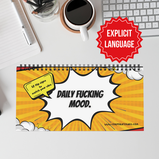 Desk sign with explicit language text on a desk with coffee and office supplies.