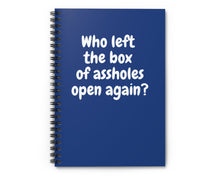 dark blue spiral notebook with sarcastic “Who left the box of assholes open again?” quote