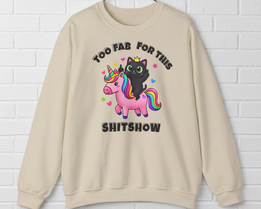 Beige sweatshirt with a graphic of a black cat on a unicorn and text 'Too Fab For This Shitshow' on a white background