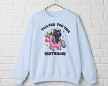 Light blue sweatshirt with a black cat and unicorn graphic and text on a white background