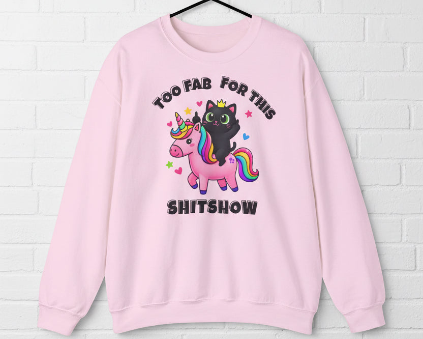Pink sweatshirt with a black cat and unicorn graphic and text on a white background