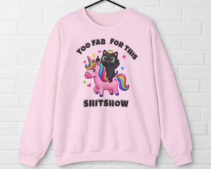 Pink sweatshirt with a black cat and unicorn graphic and text on a white background
