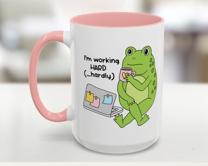 Mug with a green frog illustration and text on a white background