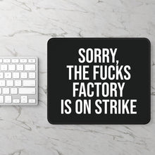 Black ‘FUCKS factory is on strike’ mouse pad on desk – lifestyle photo