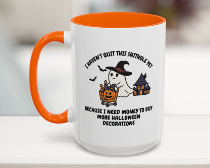 Halloween-themed mug with ghost and pumpkin design on a blurred background