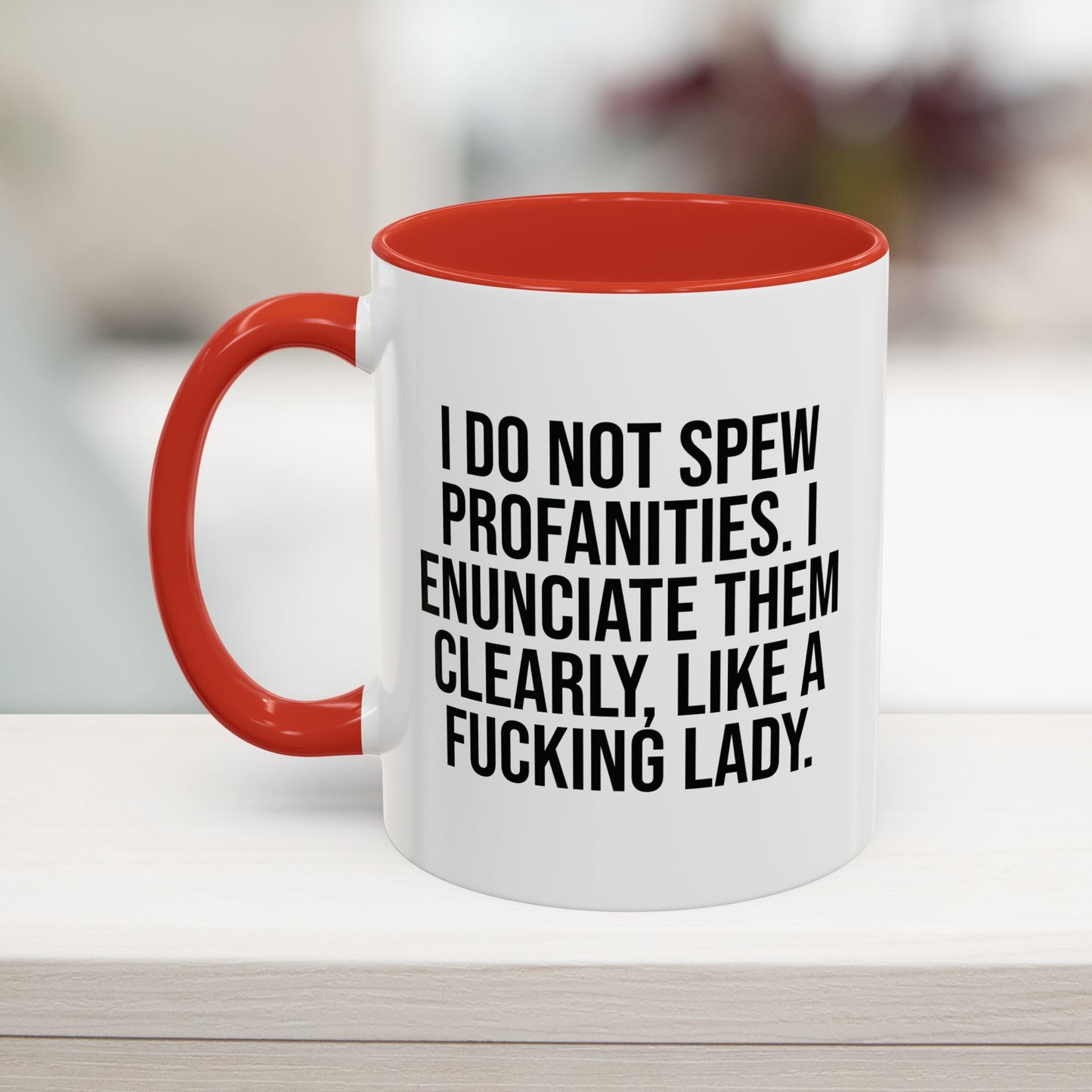 Red 11oz coffee mug with a humorous profanity quote: 'I do not spew profanities, I enunciate them clearly, like a fucking lady.' Ideal gift for women.