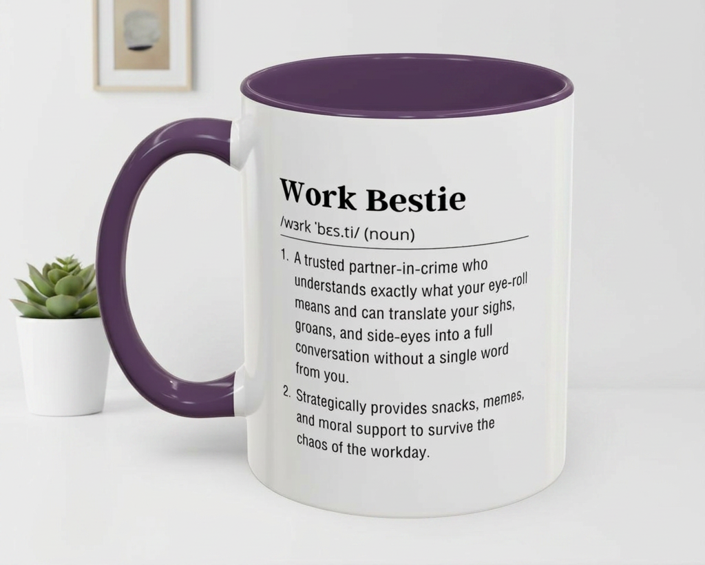 Mug with 'Work Bestie' definition text on a white surface with a plant in the background