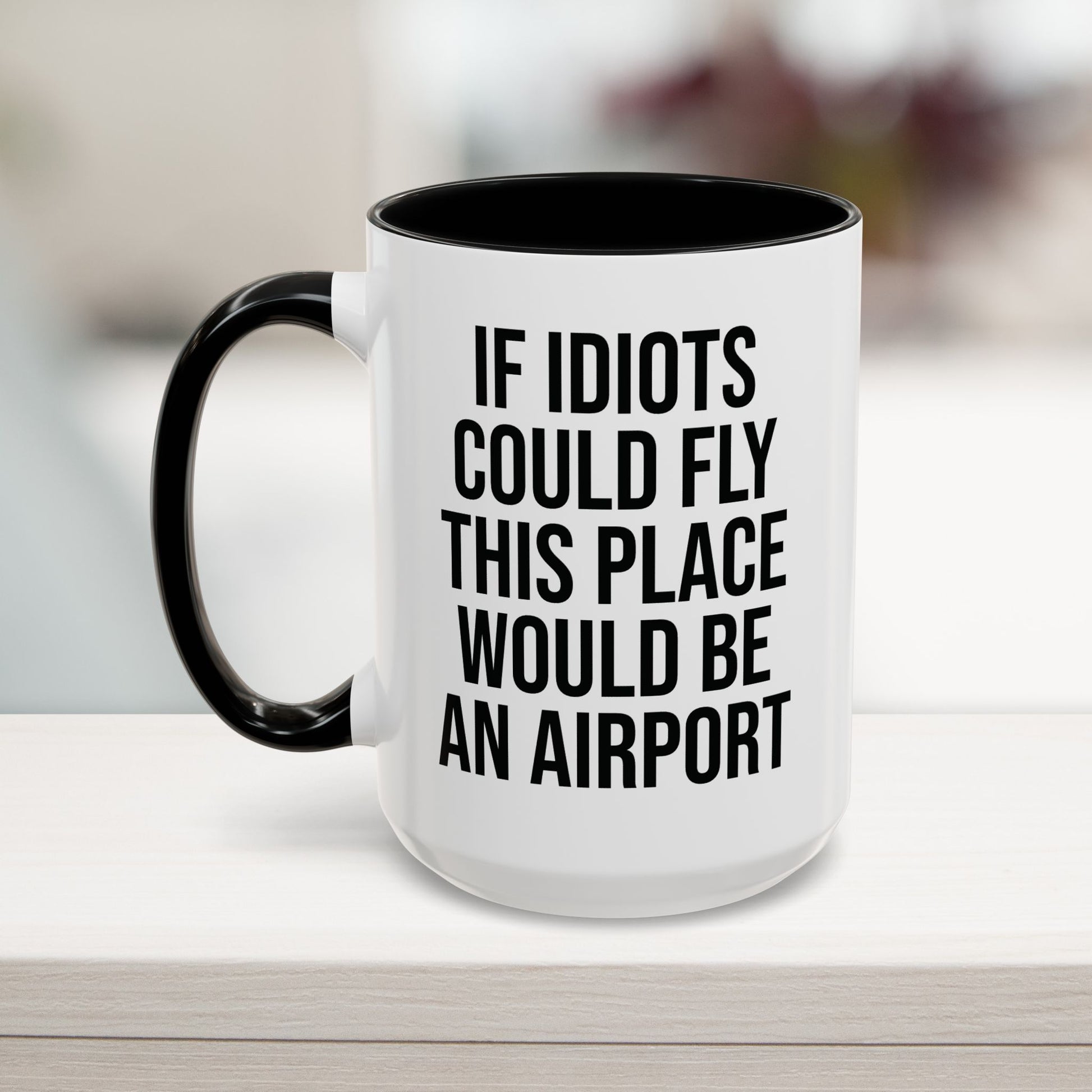 Black 15oz funny work mug with 'If Idiots Could Fly, This Place Would Be an Airport' text – sarcastic office coffee cup