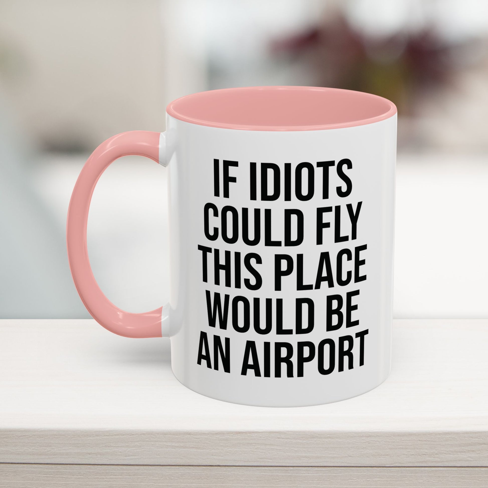 Pink 11oz funny work mug with 'If Idiots Could Fly, This Place Would Be an Airport' text – sarcastic office coffee cup