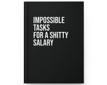 Black notebook with white text on a white background