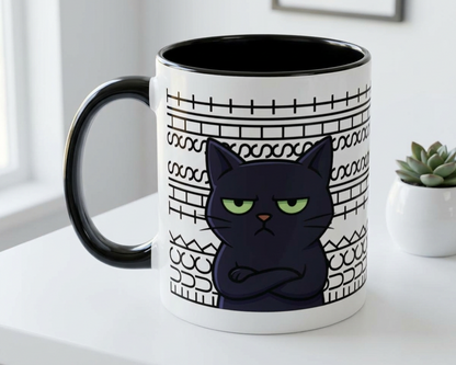 White mug with black interior and handle, featuring a black cat illustration on a white surface.