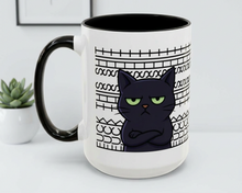 Mug with a black cat design and text on a white surface