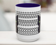 White mug with black pattern and blue interior on a blurred background