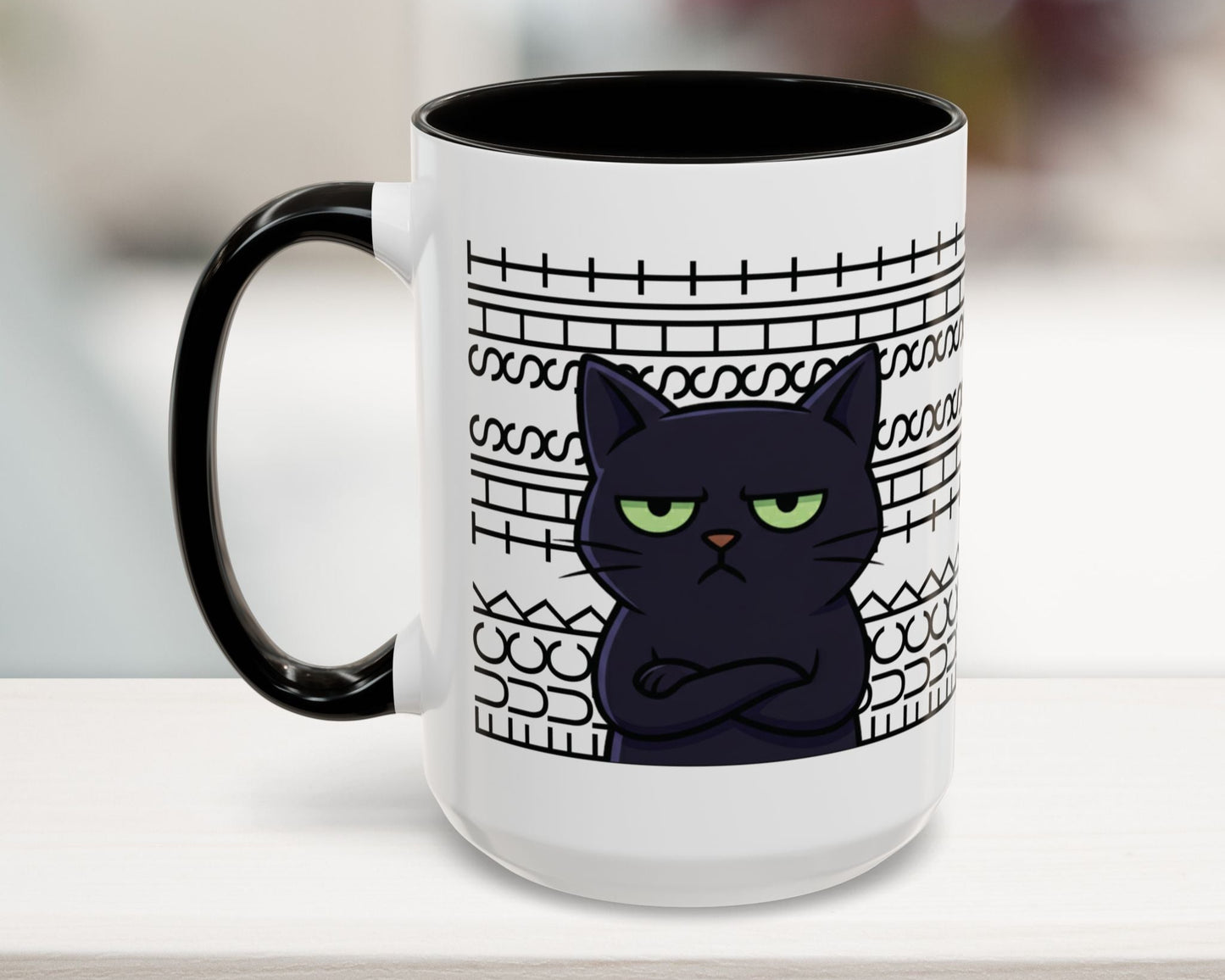 White mug with black cat design and text on a blurred background
