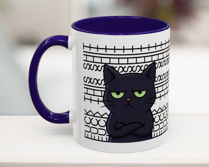 Mug with a black cat design and purple handle on a white surface