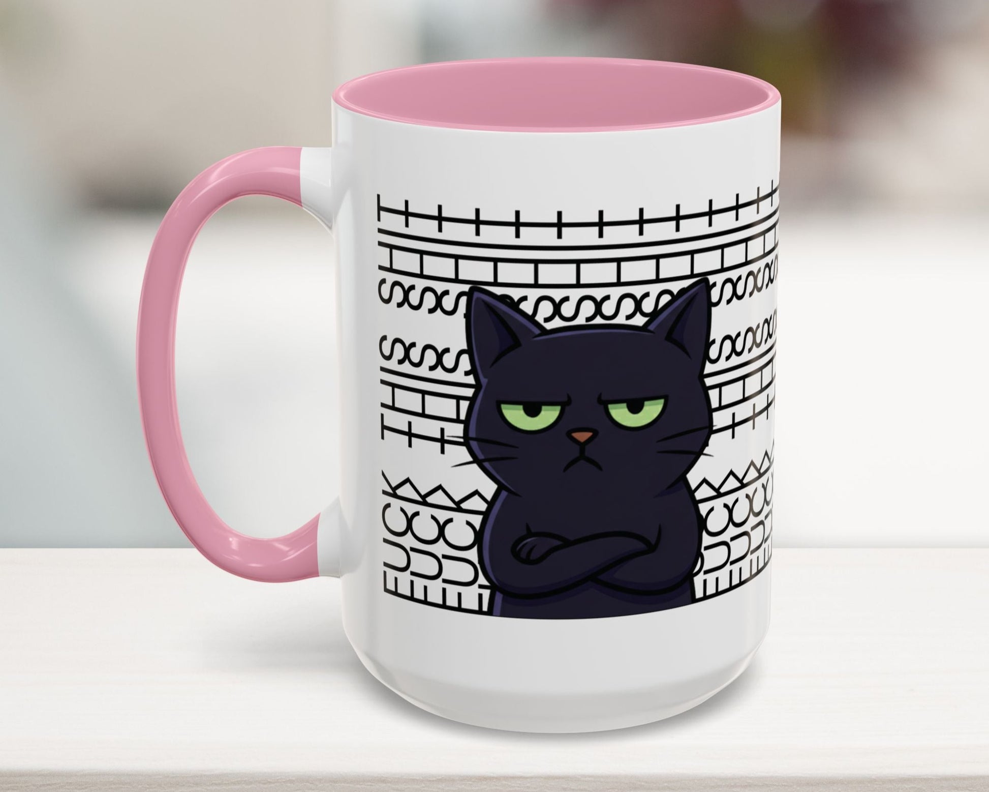White mug with pink interior and handle, featuring a black cat illustration and text on a blurred background.