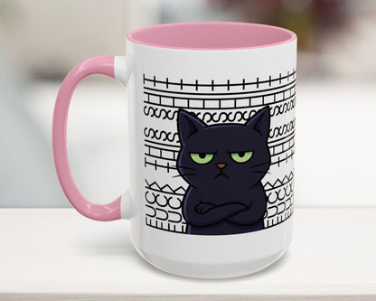 White mug with pink interior and handle, featuring a black cat illustration and text on a blurred background.