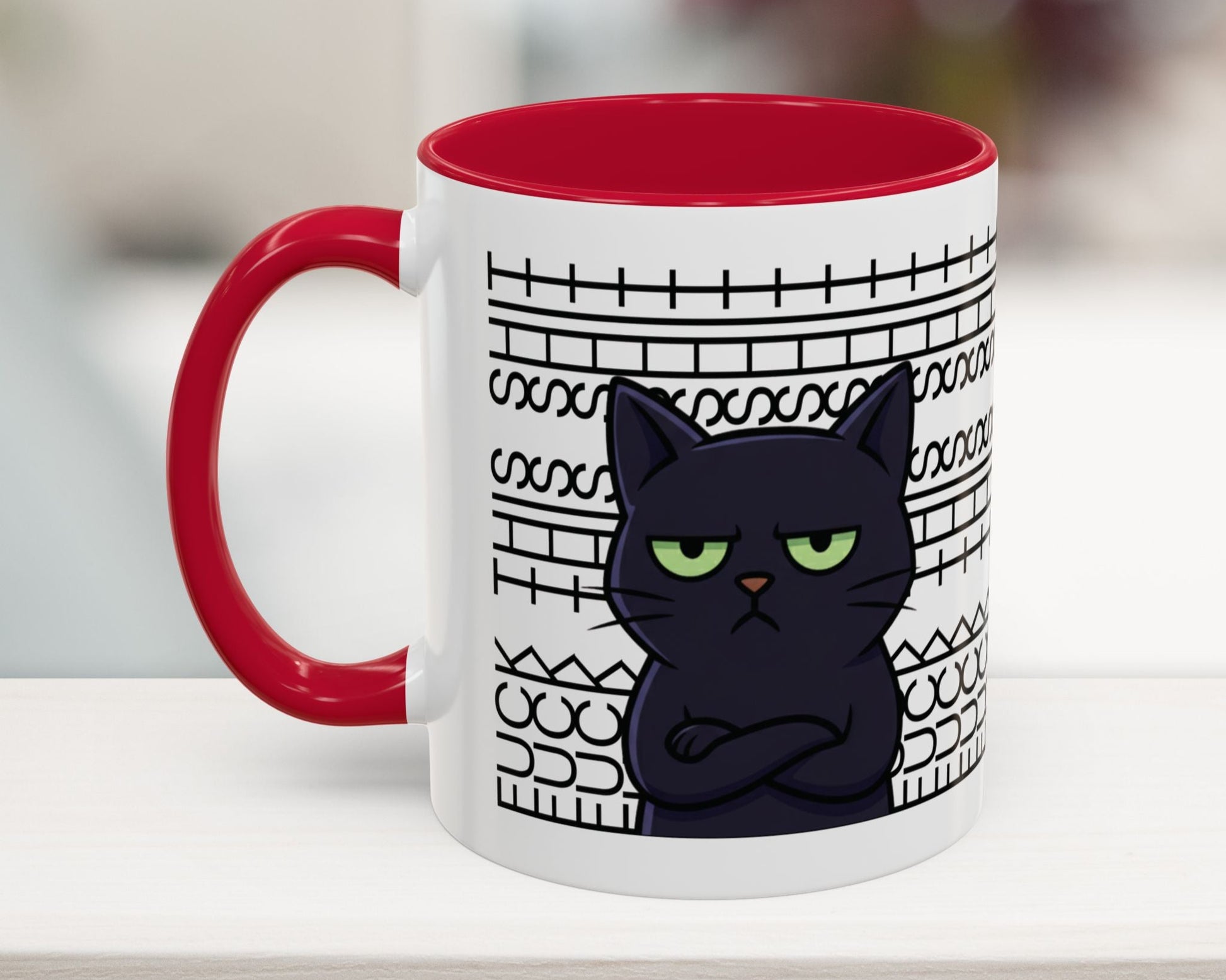 Mug with a black cat design and red interior on a blurred background