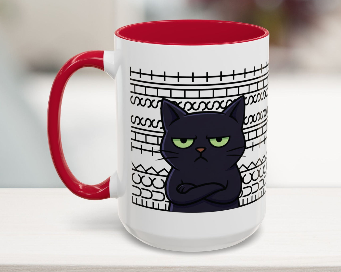 White mug with red interior and handle, featuring a black cat illustration and text on a blurred background.