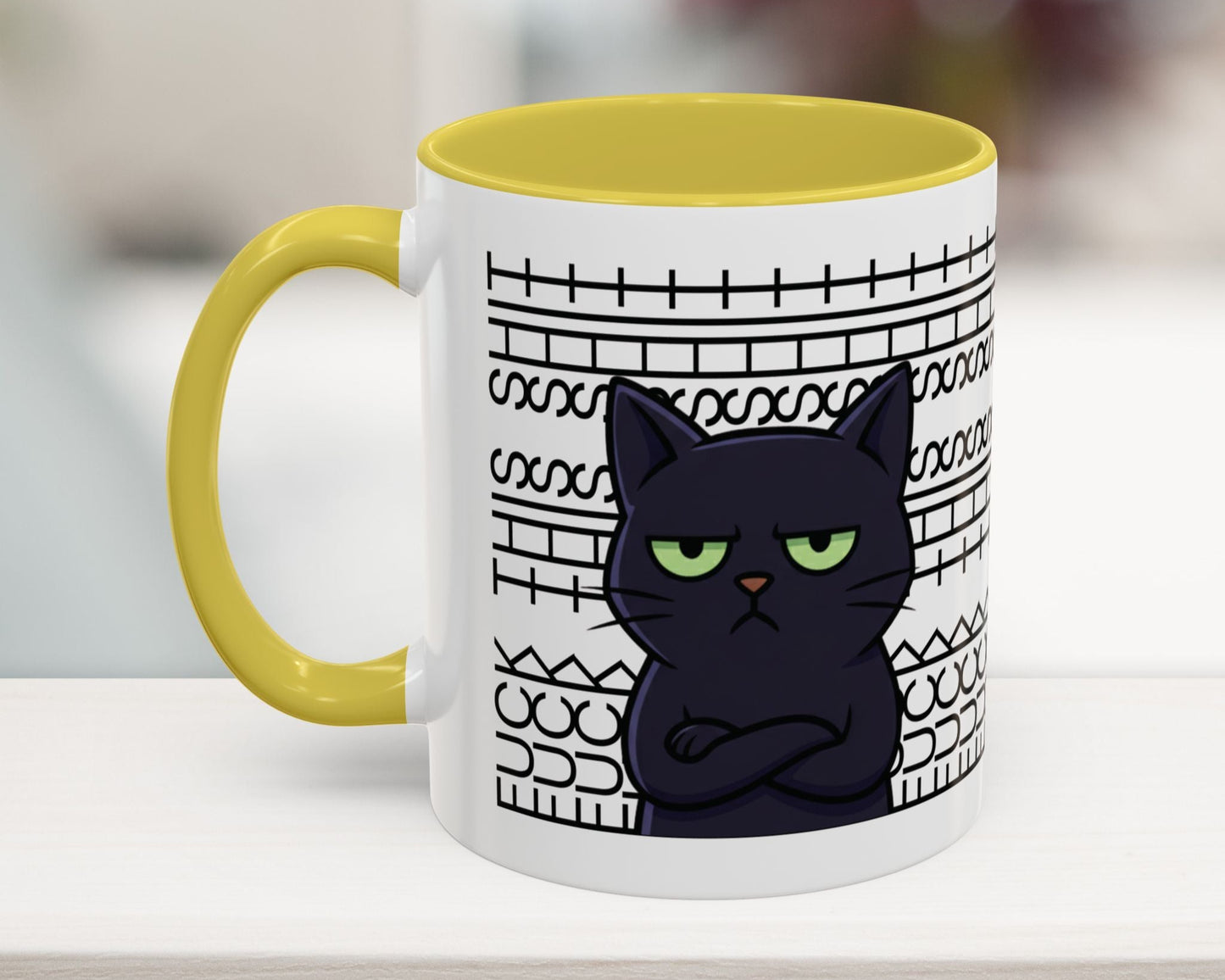 Mug with a black cat design and yellow handle on a white surface.
