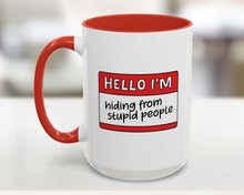 White mug with red interior and handle, featuring a humorous name tag design.