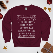 Maroon sweatshirt with Christmas-themed text and graphics on a white background with festive decorations.