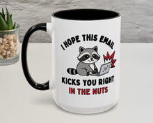 Mug with a raccoon graphic and humorous text on a white surface.