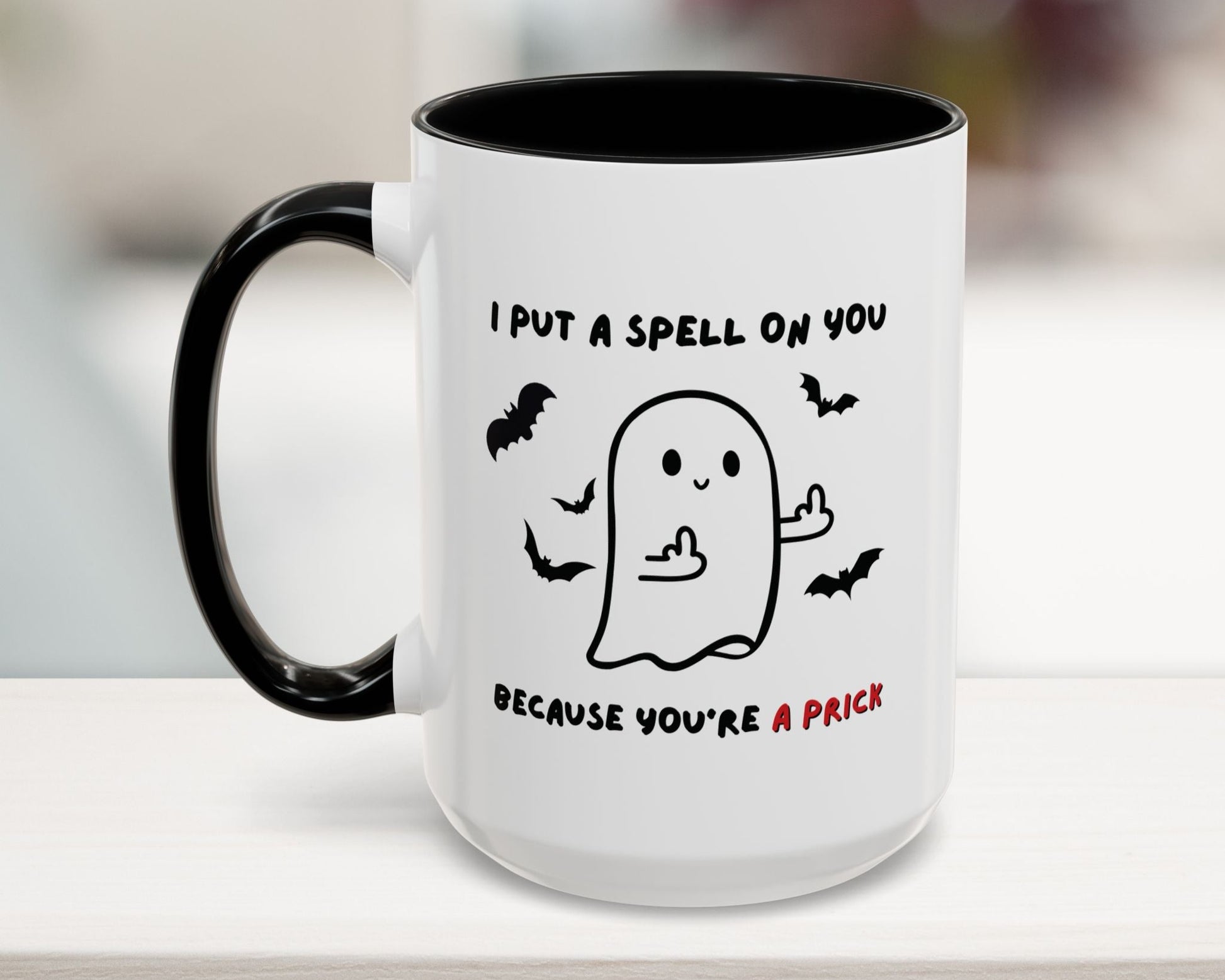 Mug with Halloween-themed design and text on a white surface