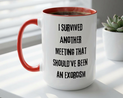 White mug with red interior and handle, featuring text on a light surface with a plant in the background.