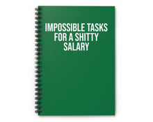 Green notebook with white text on a white background