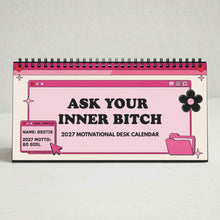 A pink and white spiral-bound desk calendar with black text reading 'ASK YOUR INNER BITCH 2027 MOTIVATIONAL DESK CALENDAR' and cartoon-style folder and flower graphics, photographed on a light neutral background.
