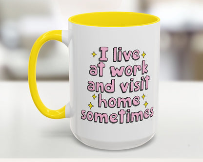 White mug with yellow interior and handle, featuring pink text on a blurred background