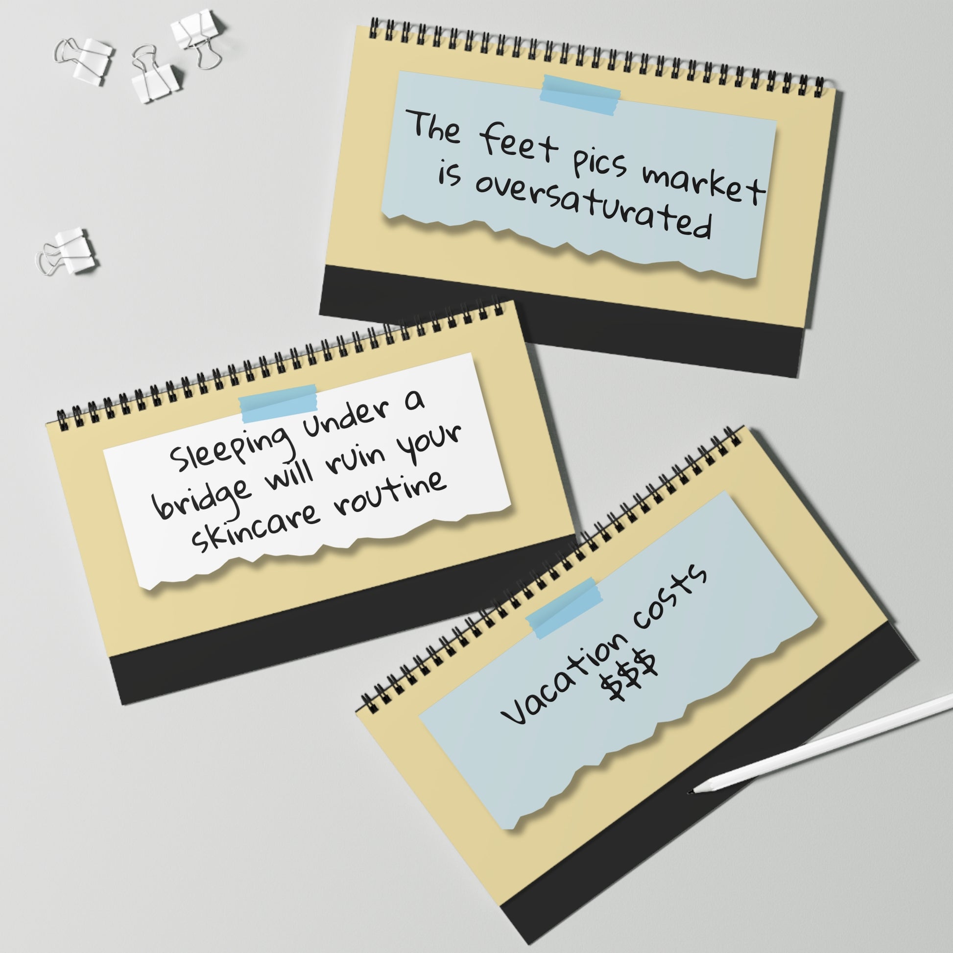 Three spiral-bound notebooks with humorous text on a light gray background