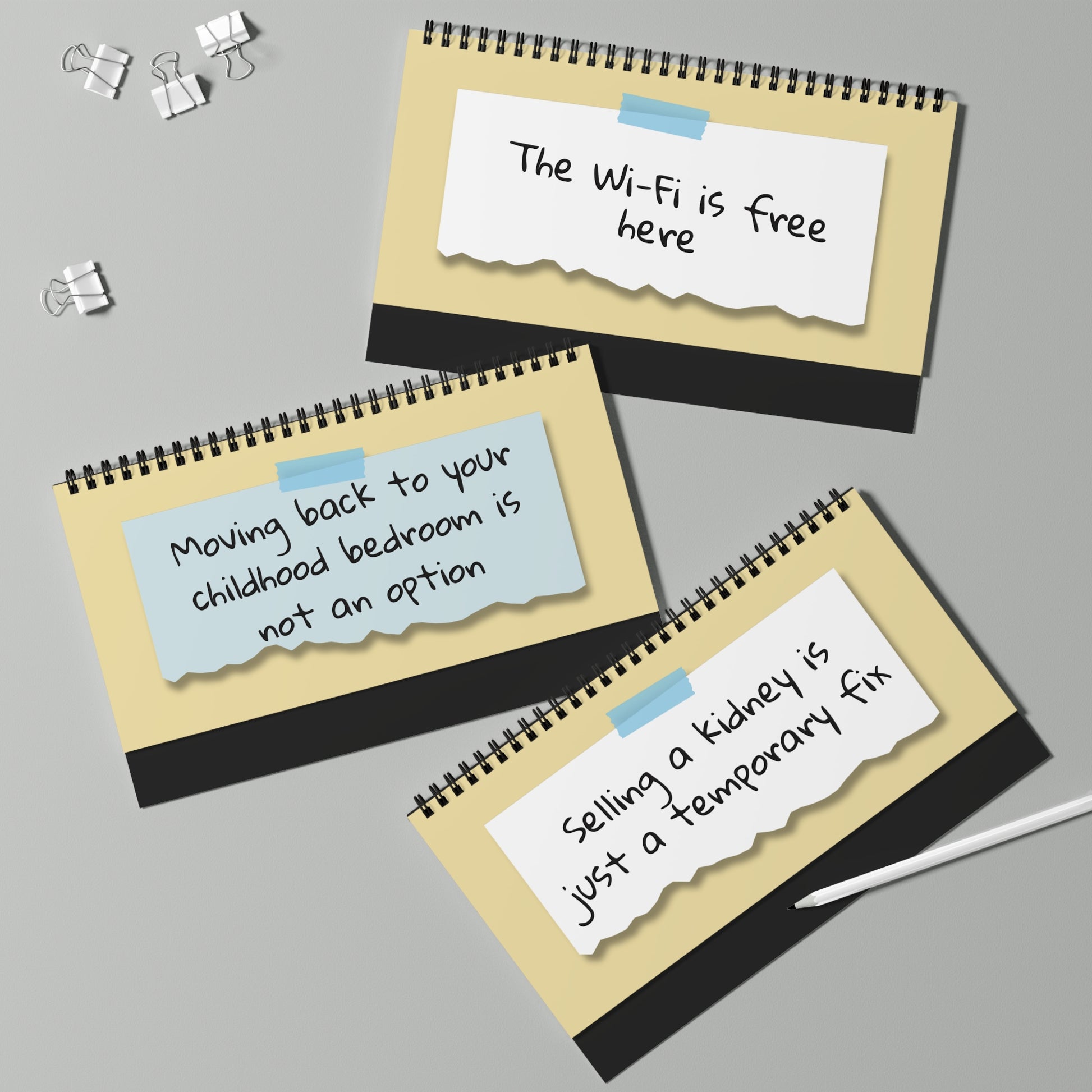 Three spiral-bound notebooks with humorous notes on a gray background