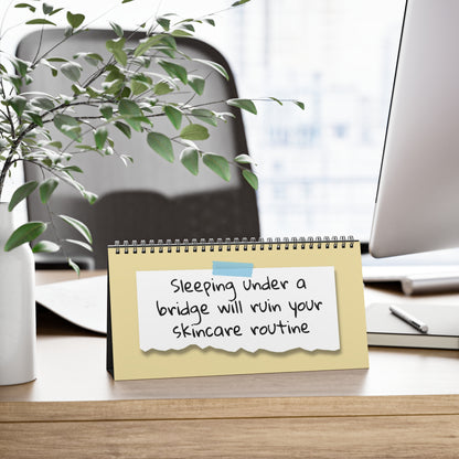 Notebook with humorous skincare advice on a desk with office items and a plant.