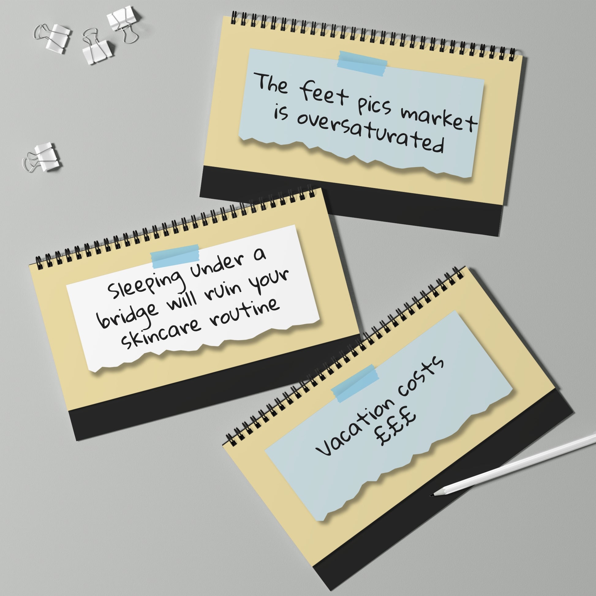 Three spiral-bound notebooks with humorous text on a gray background