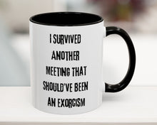 White mug with black interior and handle, featuring text on a blurred background