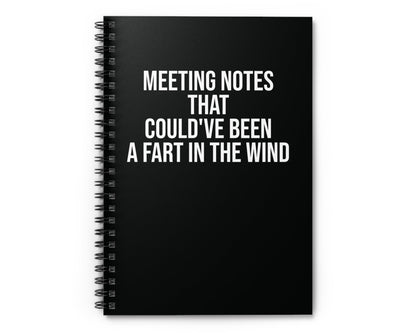 Black notebook with humorous text on a white background