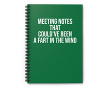 Green notebook with humorous text on a white background