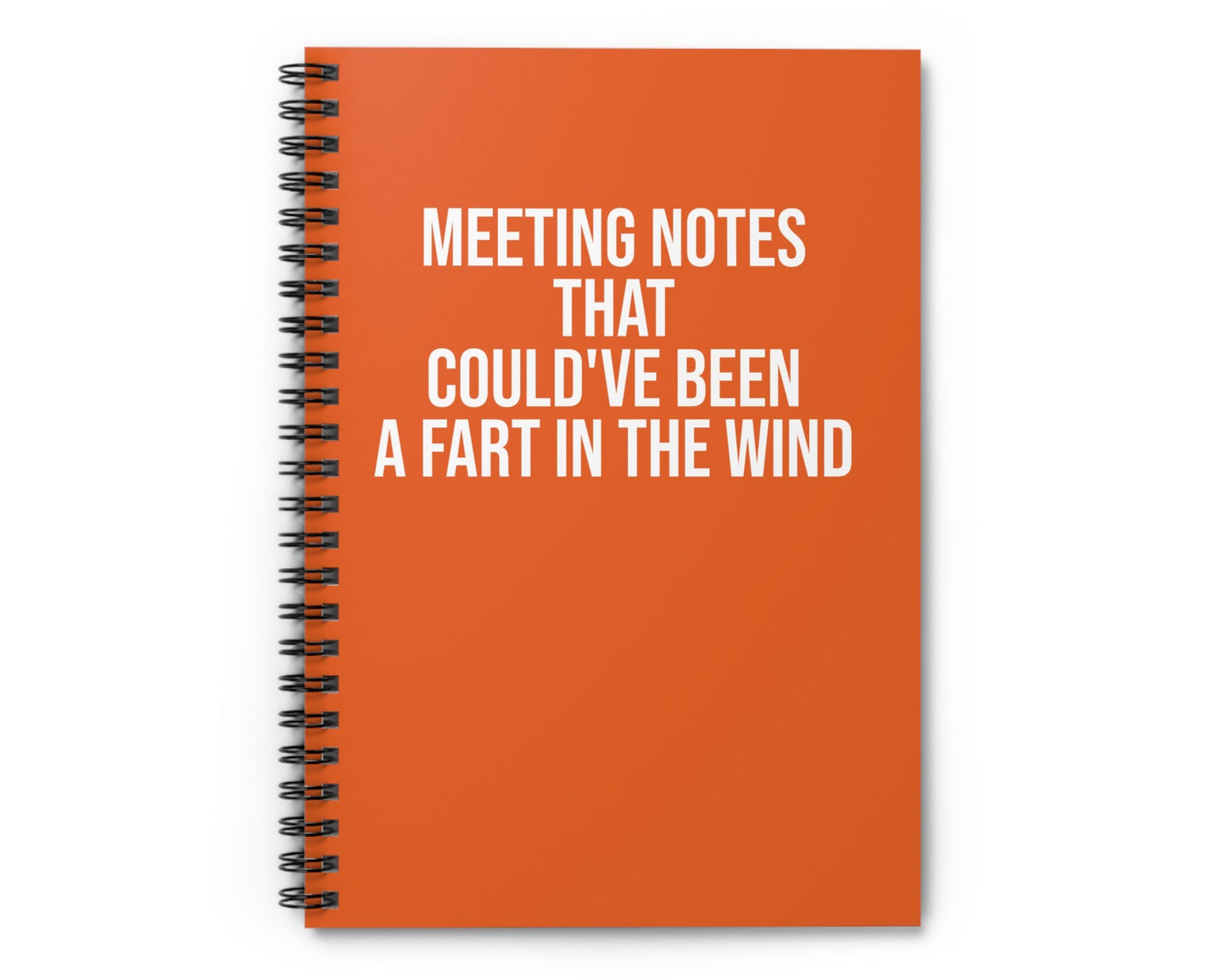 Orange notebook with humorous text on a white background