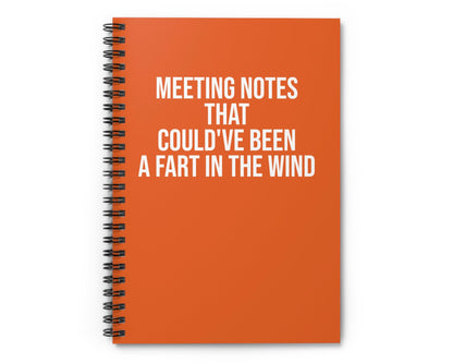 Orange notebook with humorous text on a white background
