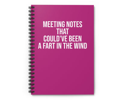 Pink notebook with humorous text on a white background