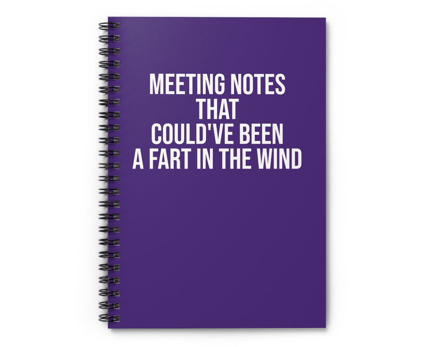 Purple notebook with humorous text on a white background